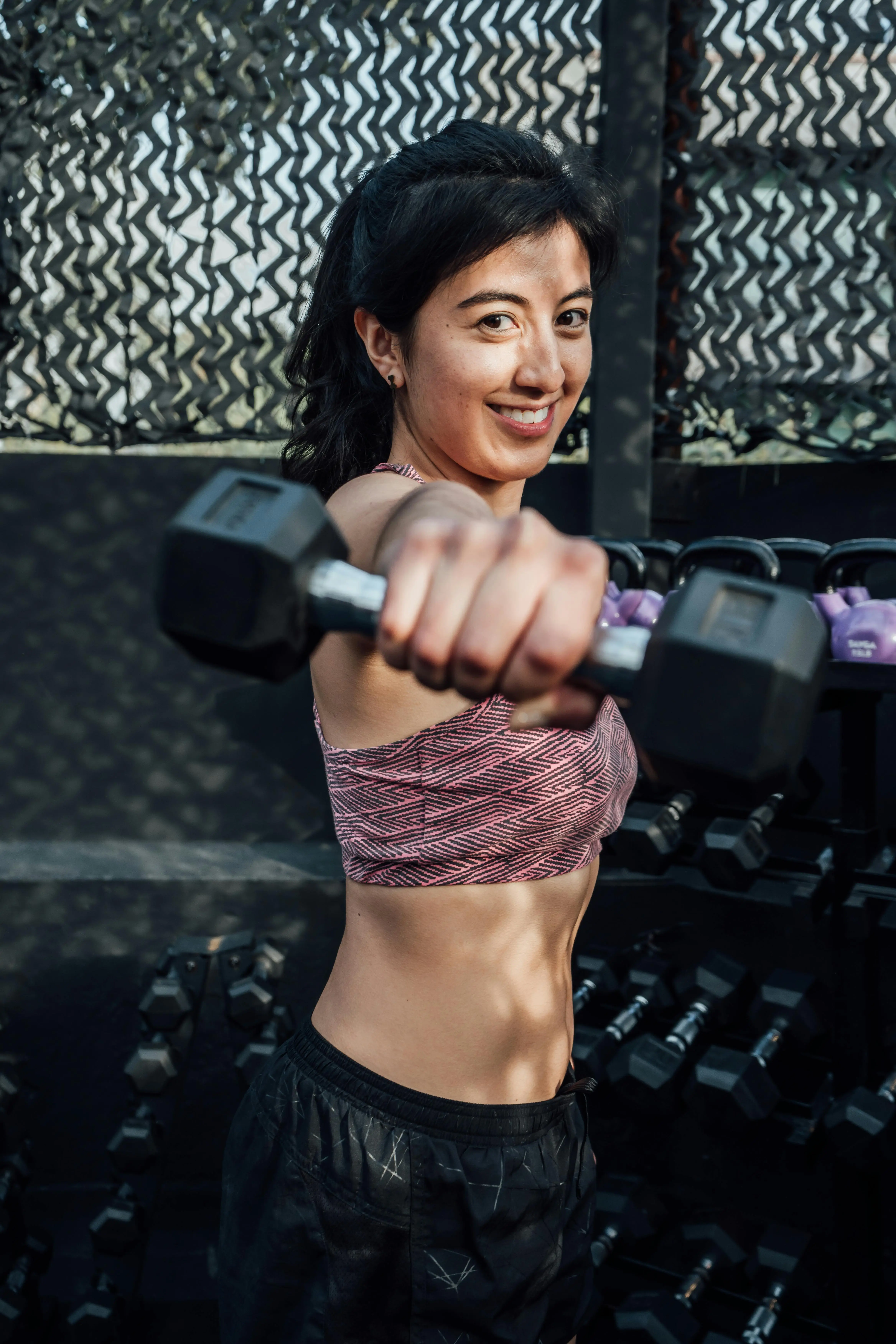 Portrait of a woman holding a dumbbell